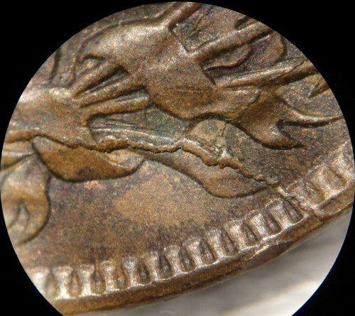 1889 Indian Head penny CUD die break error showing raised metal blob at the rim area where the die broke